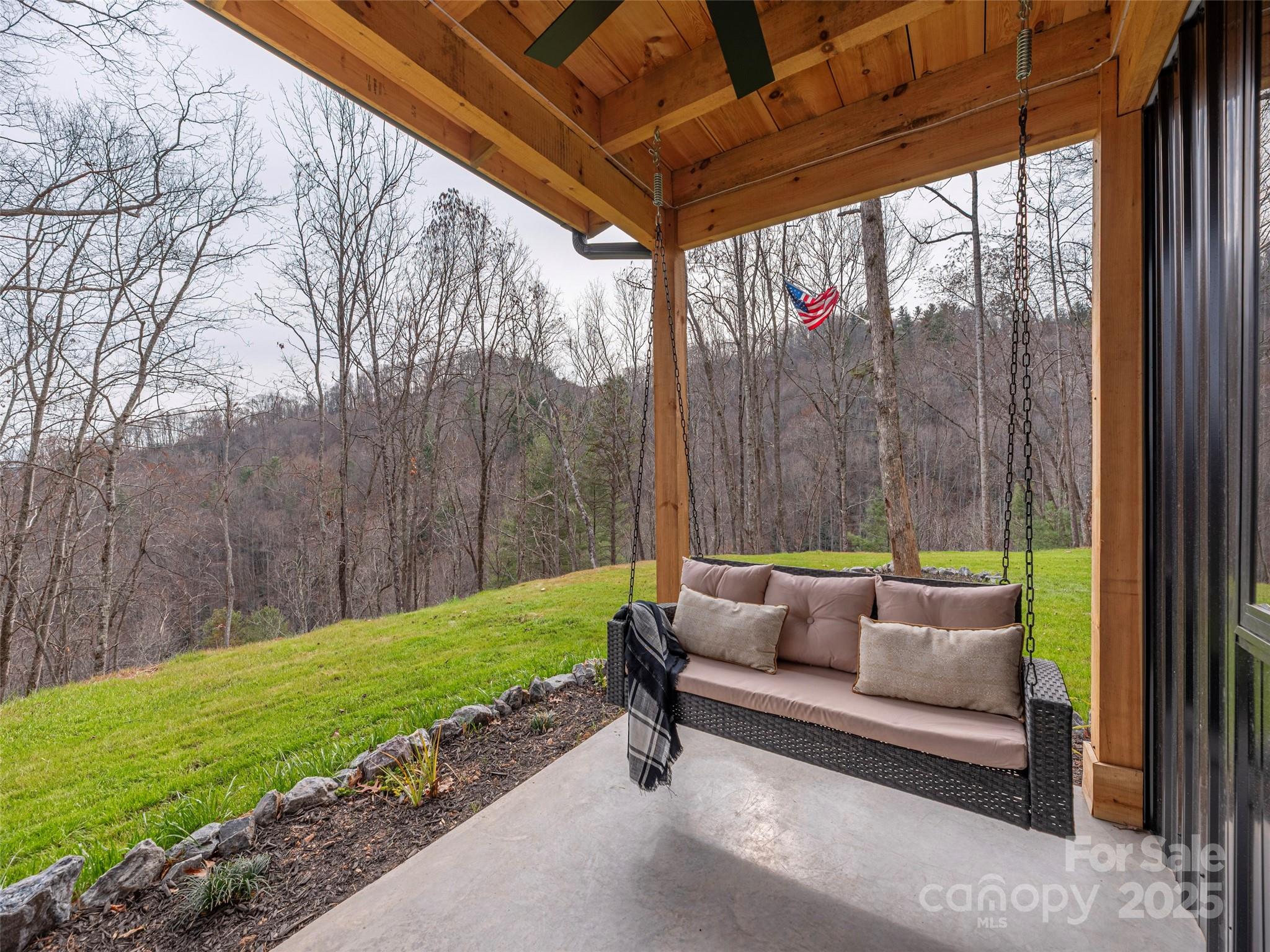 55 Dean Riddle Drive Waynesville, NC 28785 - Photo 30 of 35 a patio with glass top table and chairs
