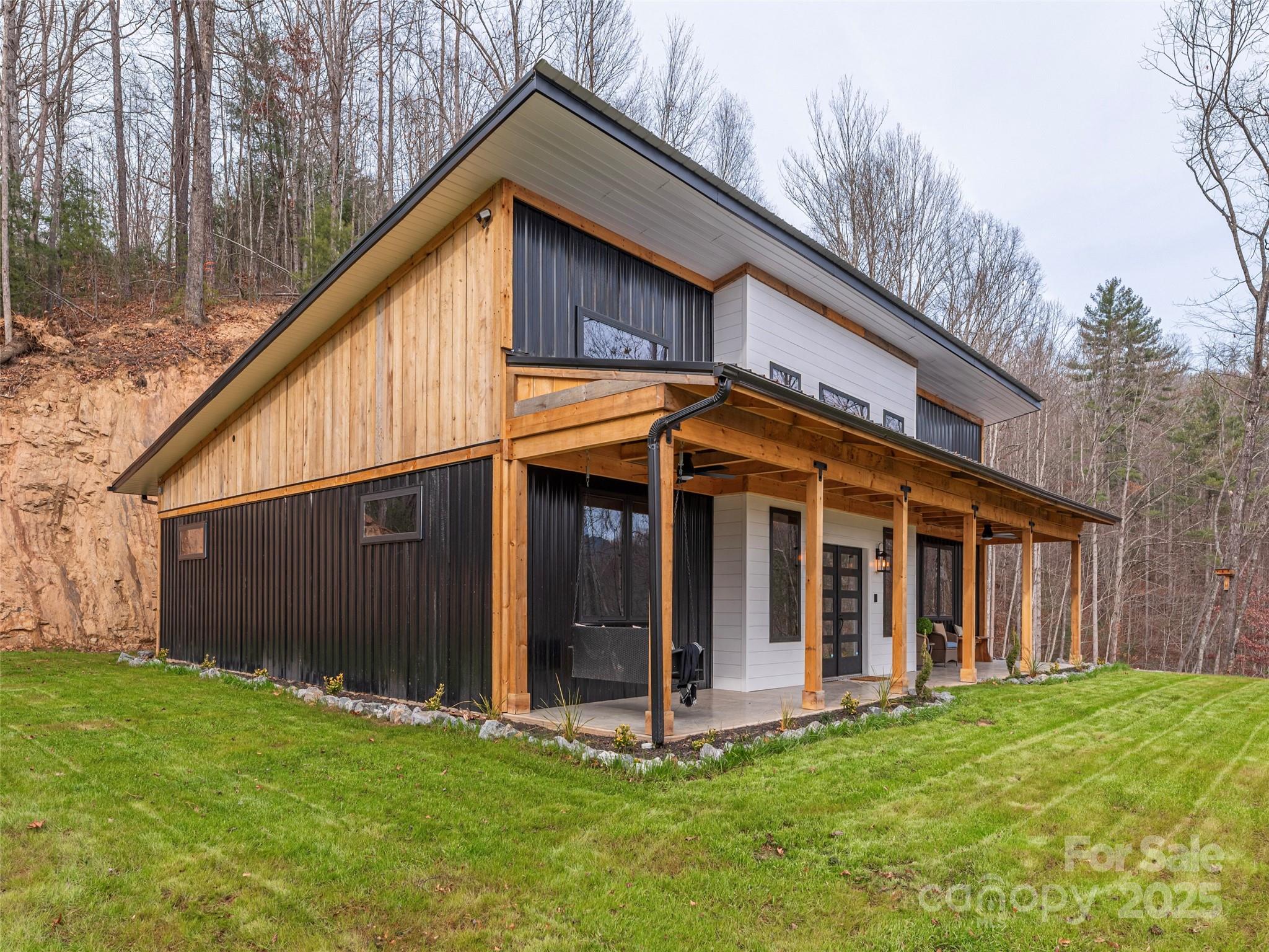 55 Dean Riddle Drive Waynesville, NC 28785 - Photo 31 of 35 a view of a house with backyard porch and garden