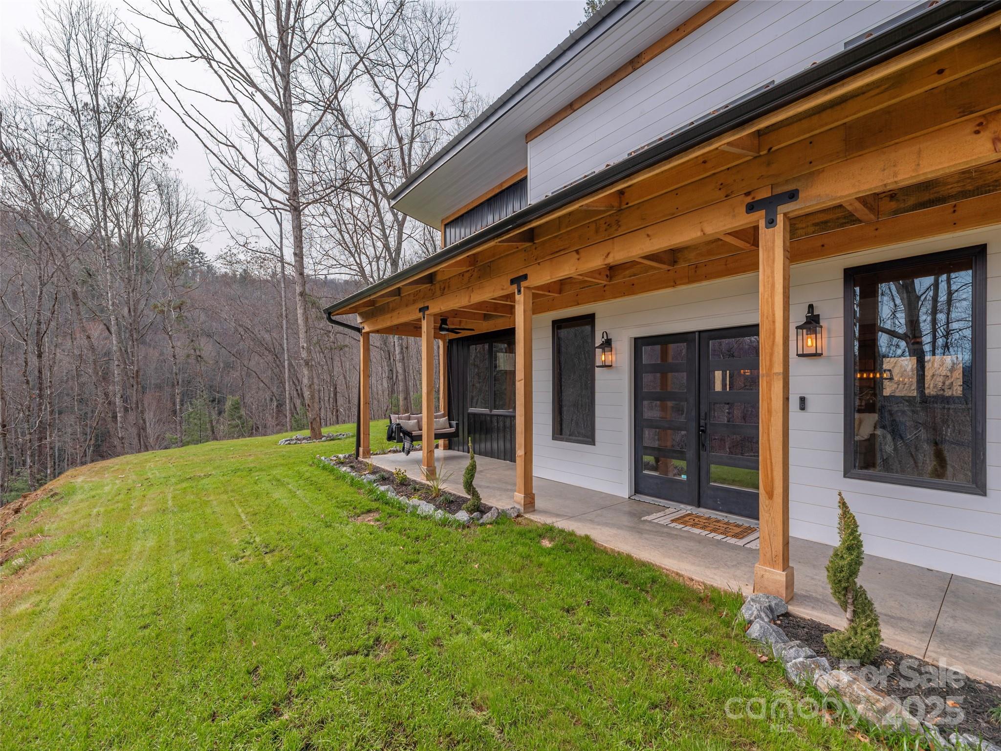 55 Dean Riddle Drive Waynesville, NC 28785 - Photo 5 of 35 a view of a backyard with table and chairs and wooden fence