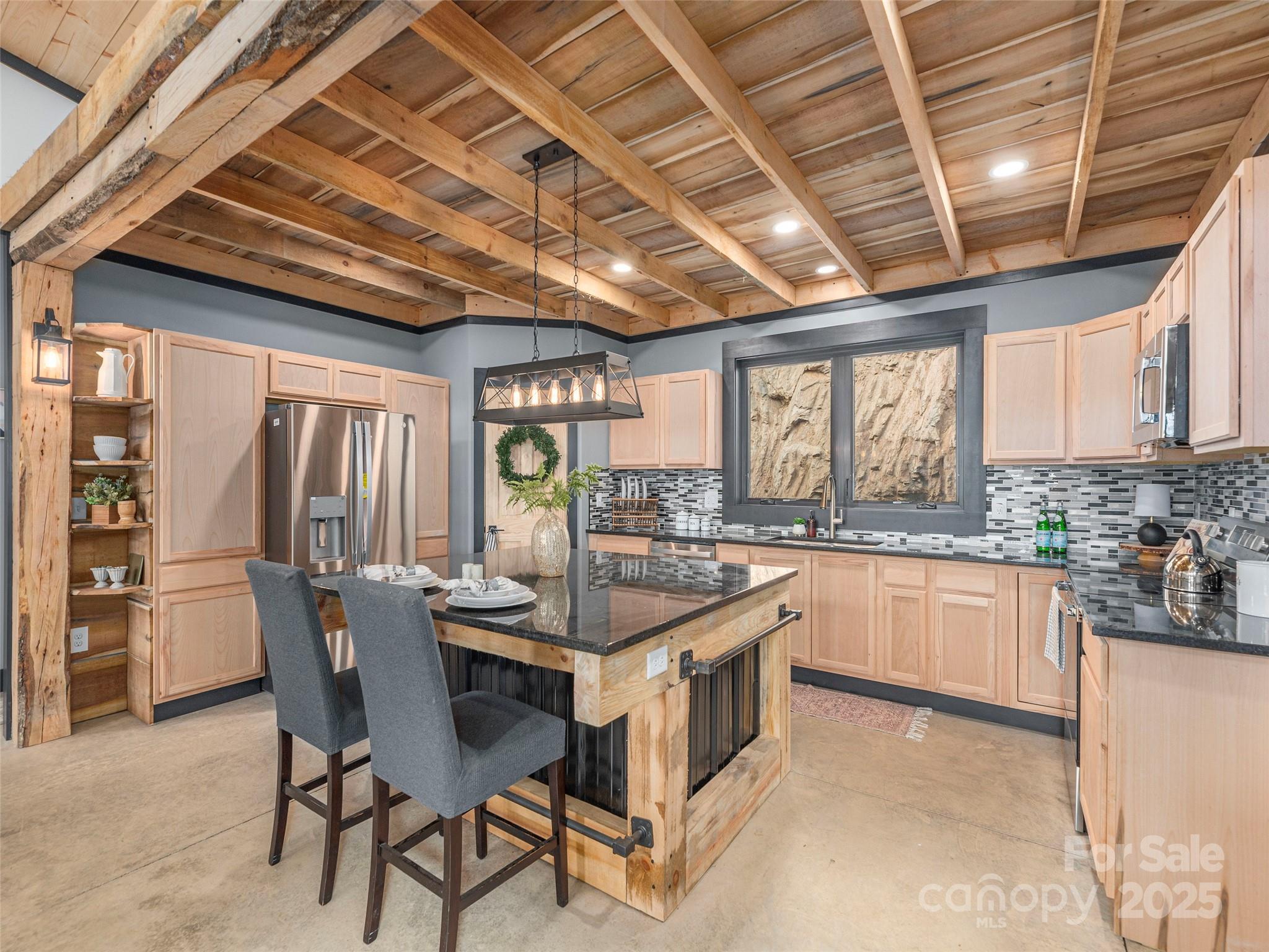 55 Dean Riddle Drive Waynesville, NC 28785 - Photo 10 of 35 a dining room with furniture large windows and wooden floor