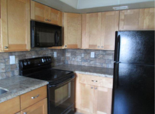 1911 Northeast 27th Court, Unit 13 Lighthouse Point, FL 33064 - Photo 38 of 61 a kitchen with a sink and a microwave