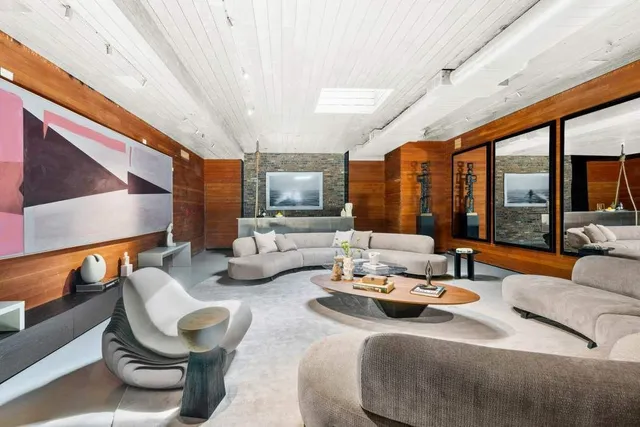 a view of a patio with couches table and chairs and potted plants