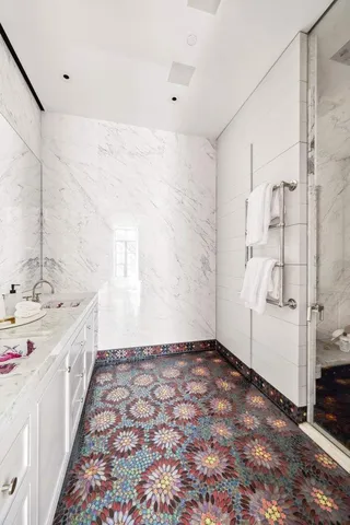 a bedroom with a bed and a large window with outer view