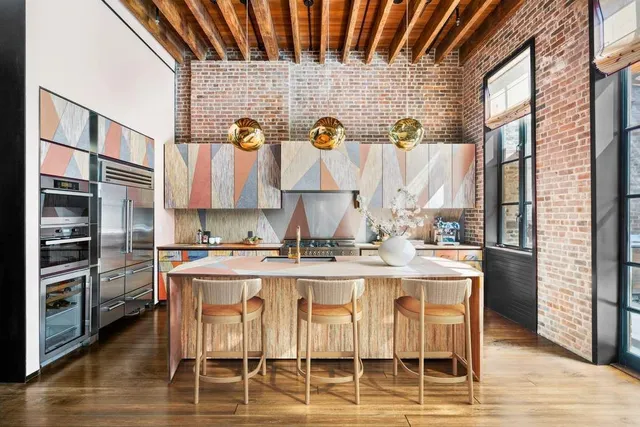 a living room with furniture a large window and wooden floor