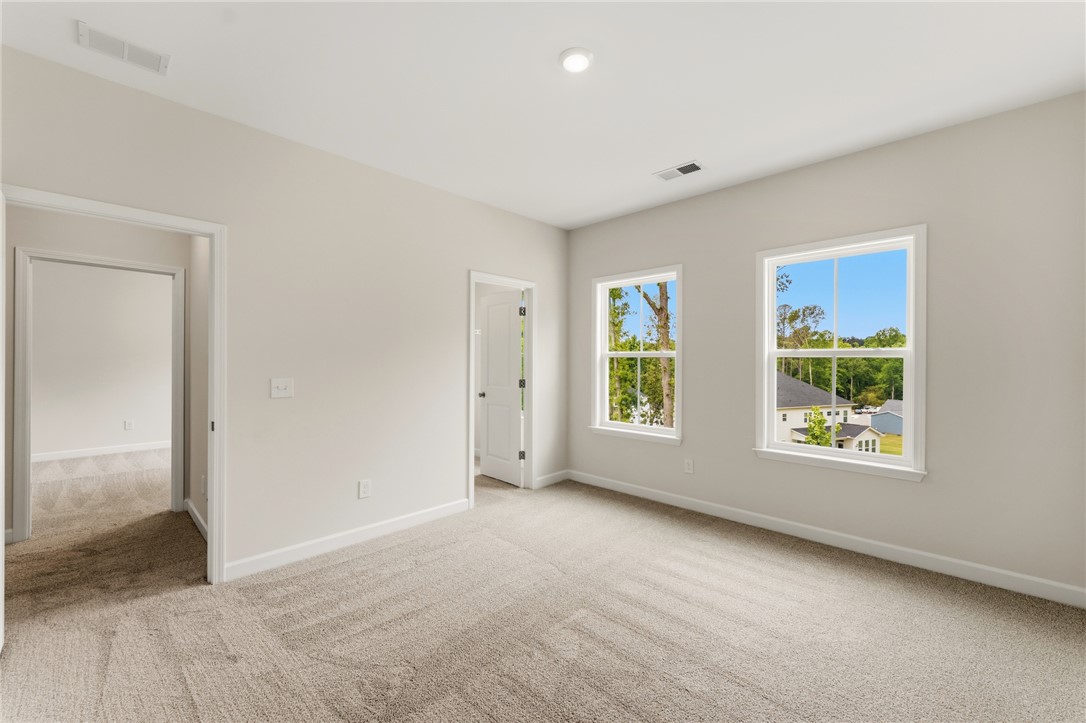 405 Botany Lane Anderson, SC 29621 - Photo 29 of 30 This spacious room features ample natural light and plush carpet flooring, ready for personalization.