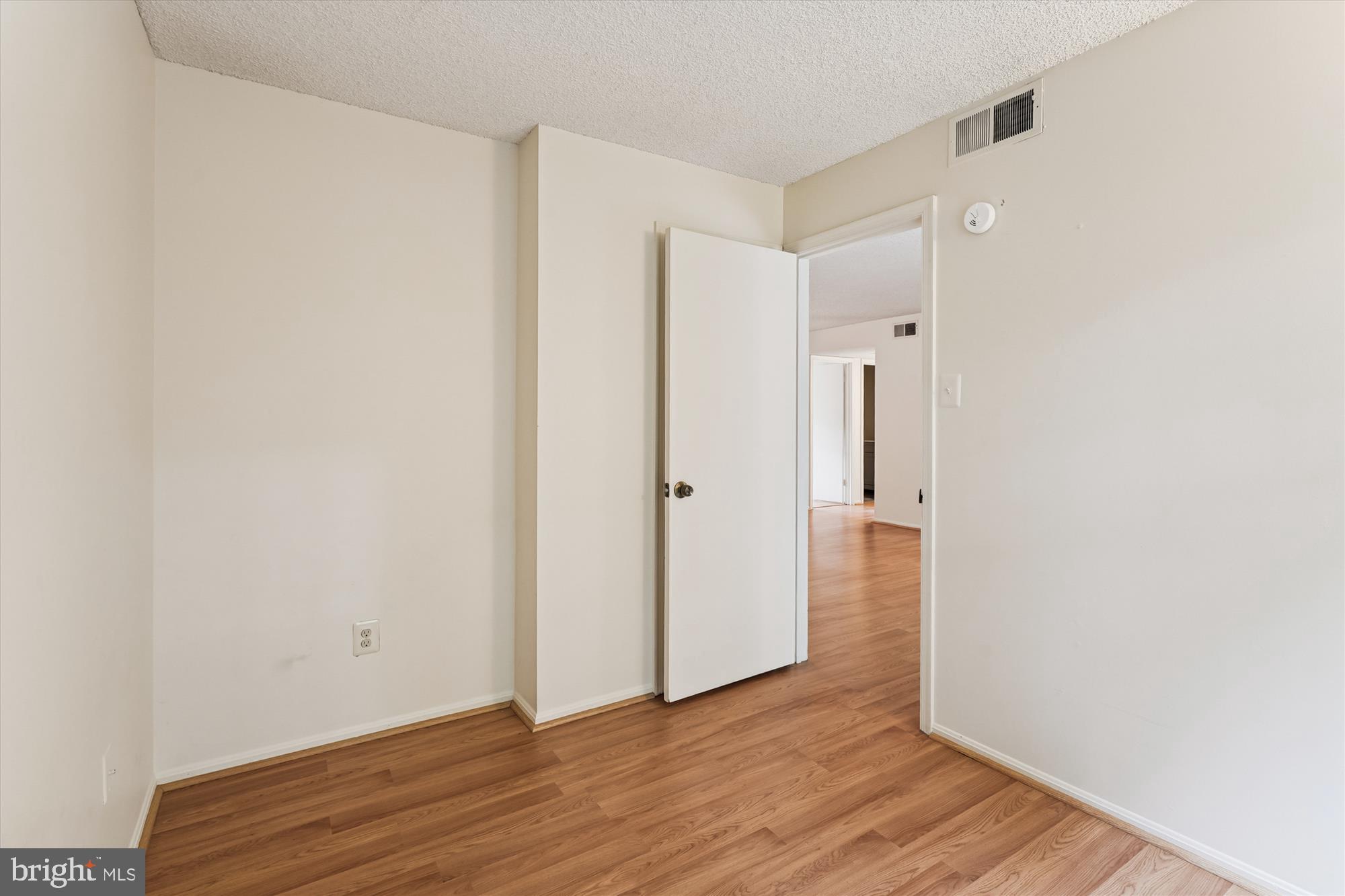 12129 Chaucer Lane, Unit 12129 Woodbridge, VA 22192 - Photo 13 of 31 a view of an empty room with wooden floor