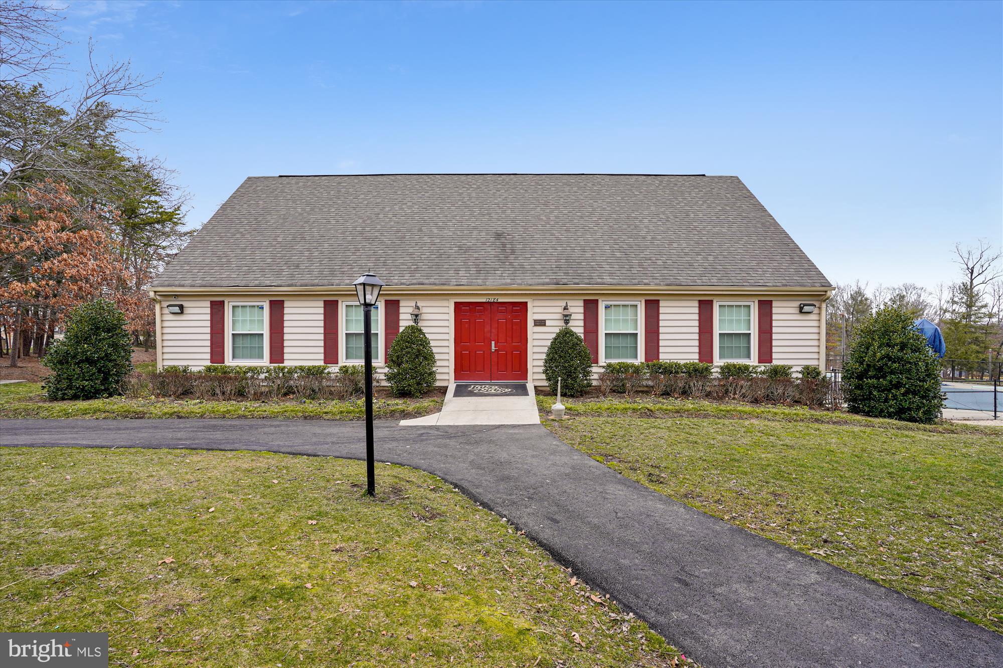 12129 Chaucer Lane, Unit 12129 Woodbridge, VA 22192 - Photo 29 of 31 a front view of a house with garden