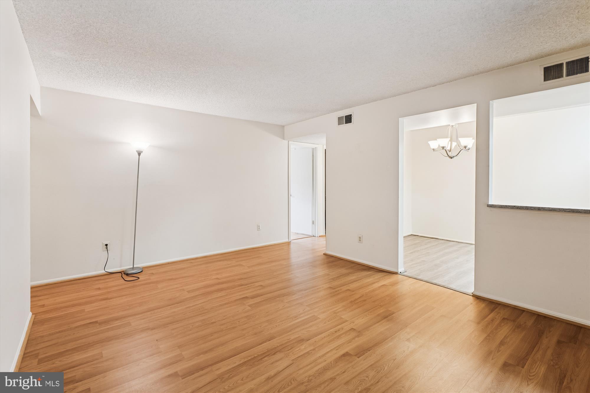 12129 Chaucer Lane, Unit 12129 Woodbridge, VA 22192 - Photo 4 of 31 a view of an empty room with wooden floor and a window