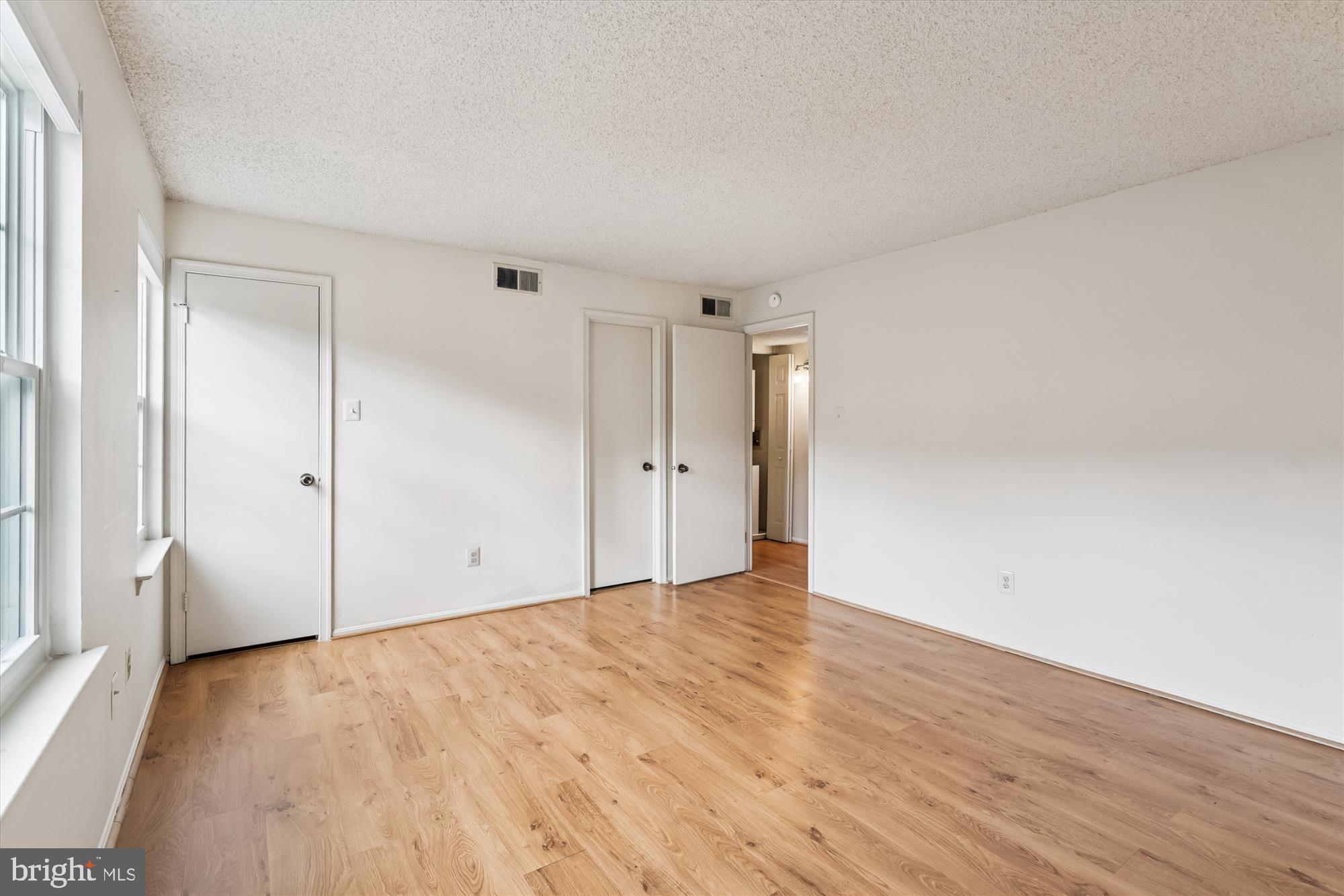 12129 Chaucer Lane, Unit 12129 Woodbridge, VA 22192 - Photo 10 of 31 a view of an empty room with wooden floor