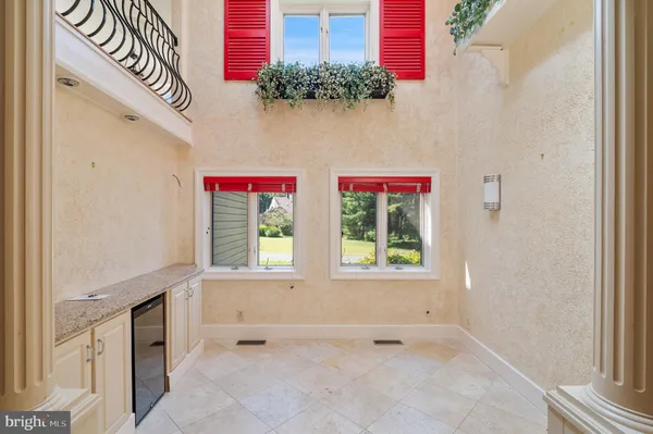 a view of hallway with a large window and wooden floor