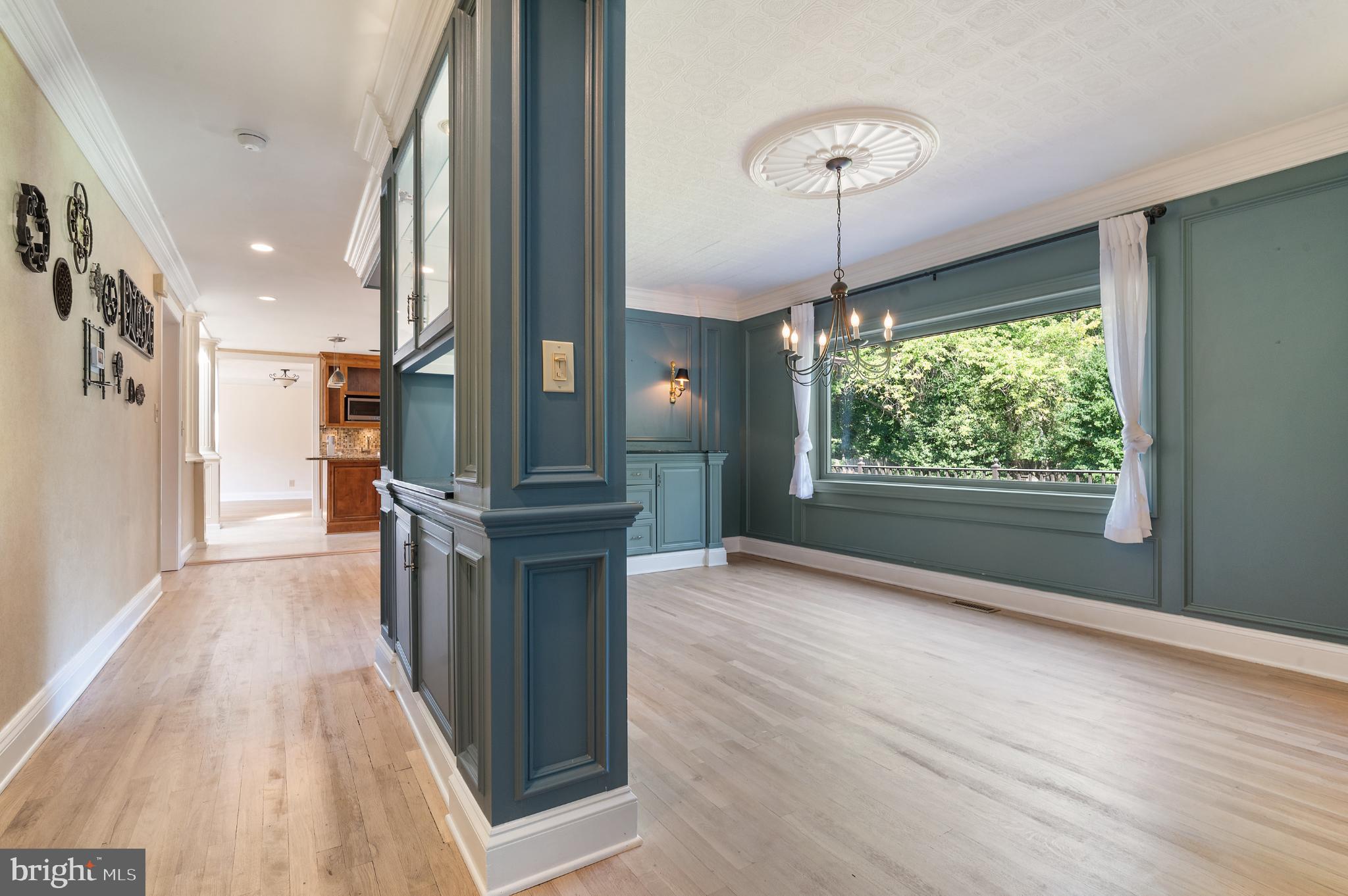 15729 Holly Grove Road Silver Spring, MD 20905 - Photo 35 of 83 a view of a hallway with wooden floor and a chandelier
