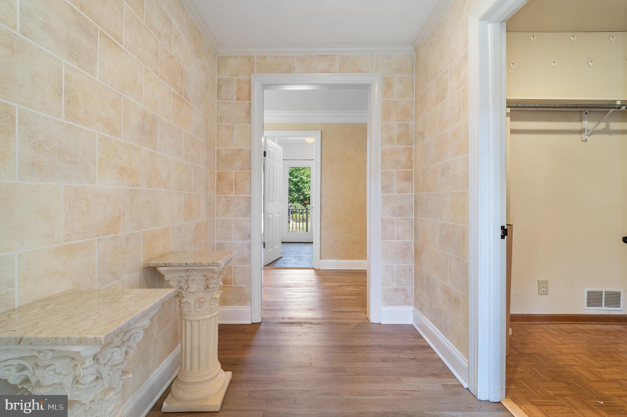 15729 Holly Grove Road Silver Spring, MD 20905 - Photo 38 of 83 a view of a hallway with wooden floor and a bathroom
