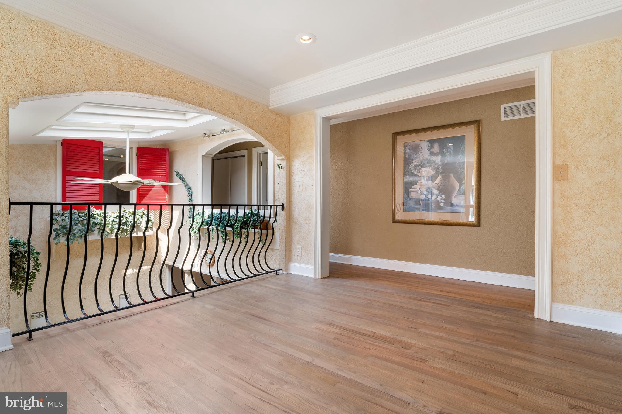 15729 Holly Grove Road Silver Spring, MD 20905 - Photo 42 of 83 a view of a hallway with wooden floor and windows