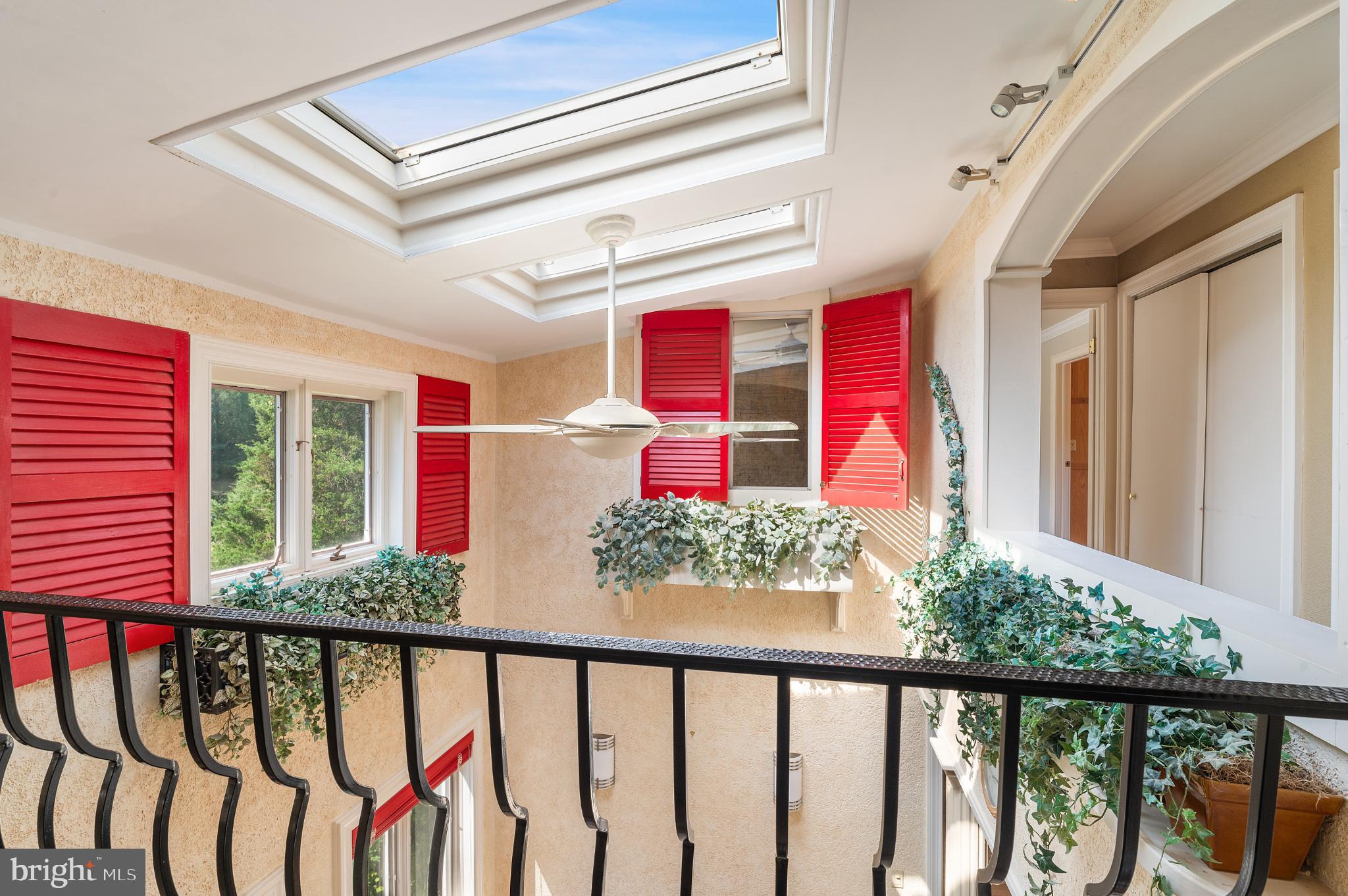 15729 Holly Grove Road Silver Spring, MD 20905 - Photo 44 of 83 Bright atrium with red shutters and greenery.