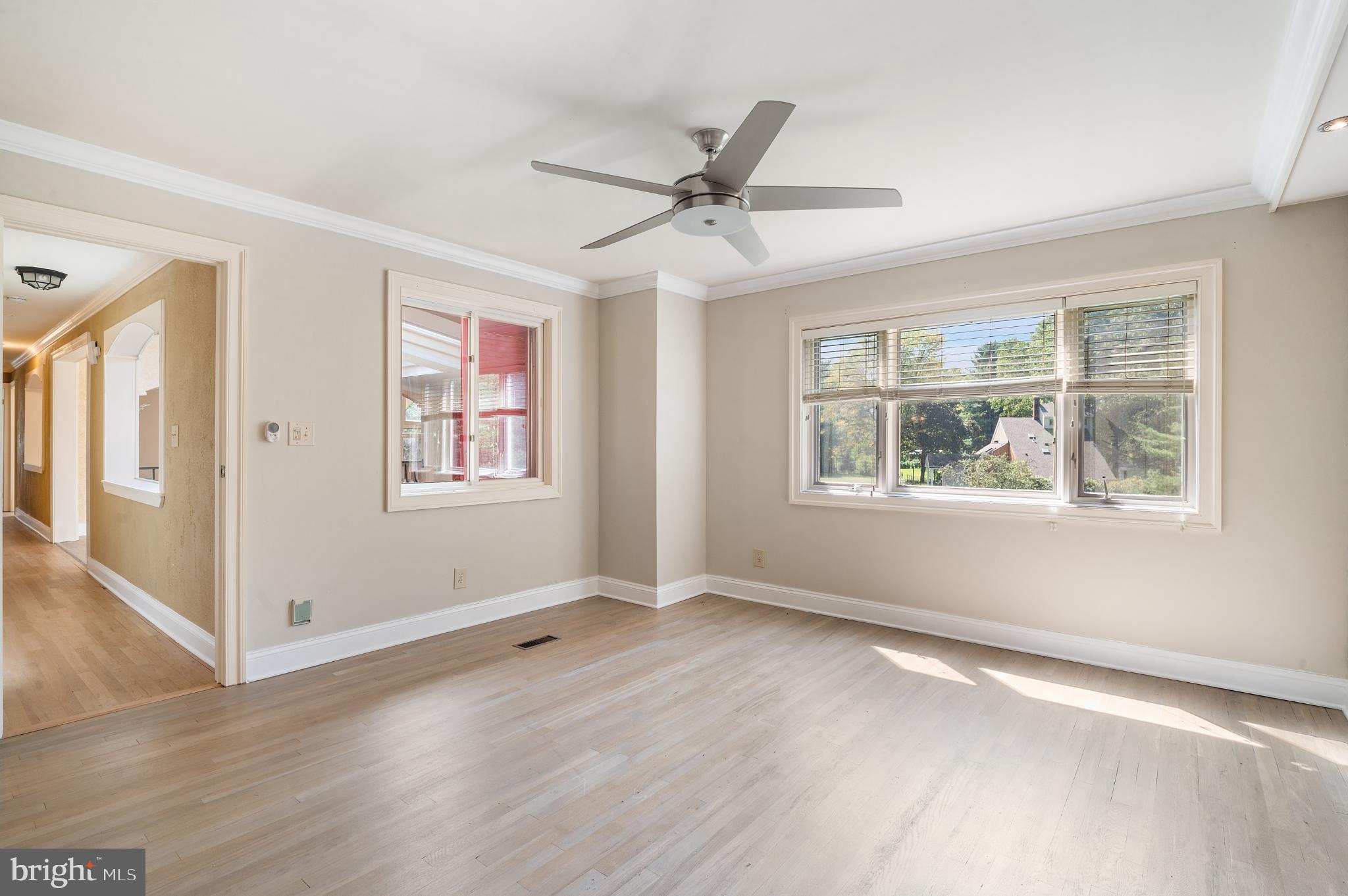 15729 Holly Grove Road Silver Spring, MD 20905 - Photo 49 of 83 a view of an empty room with wooden floor and a window