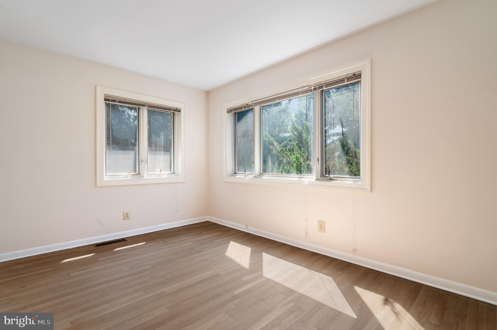 15729 Holly Grove Road Silver Spring, MD 20905 - Photo 59 of 83 a view of an empty room with wooden floor and a window