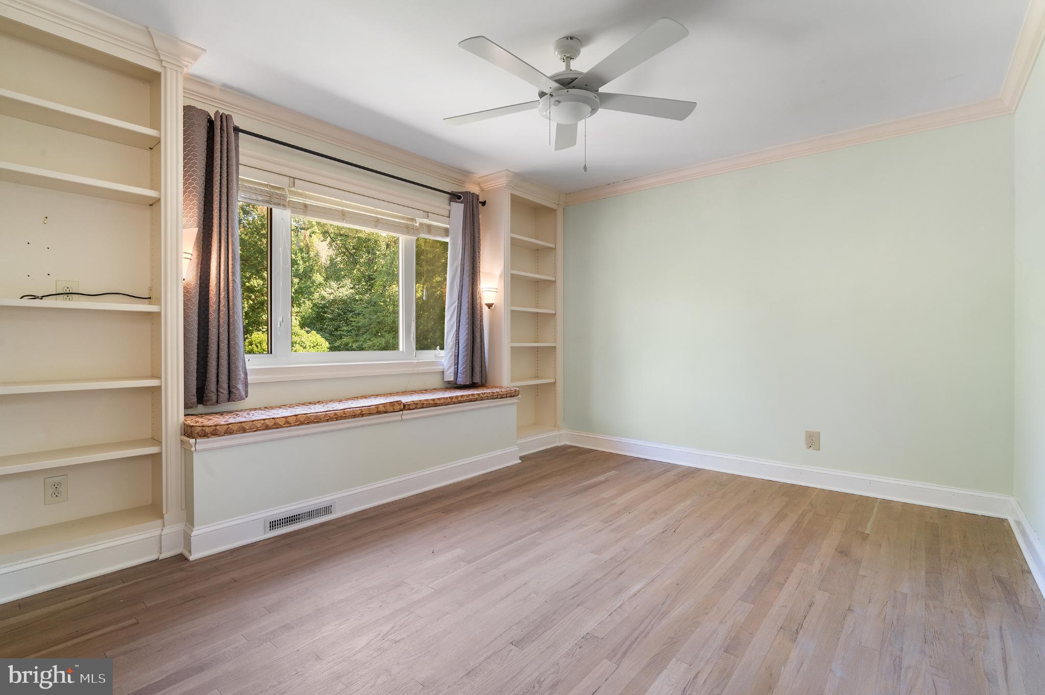 15729 Holly Grove Road Silver Spring, MD 20905 - Photo 63 of 83 a view of an empty room with a window and wooden floor