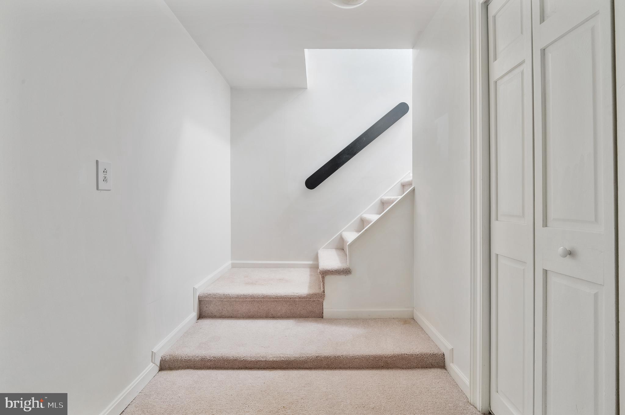 15729 Holly Grove Road Silver Spring, MD 20905 - Photo 69 of 83 a view of staircase with white walls and railing