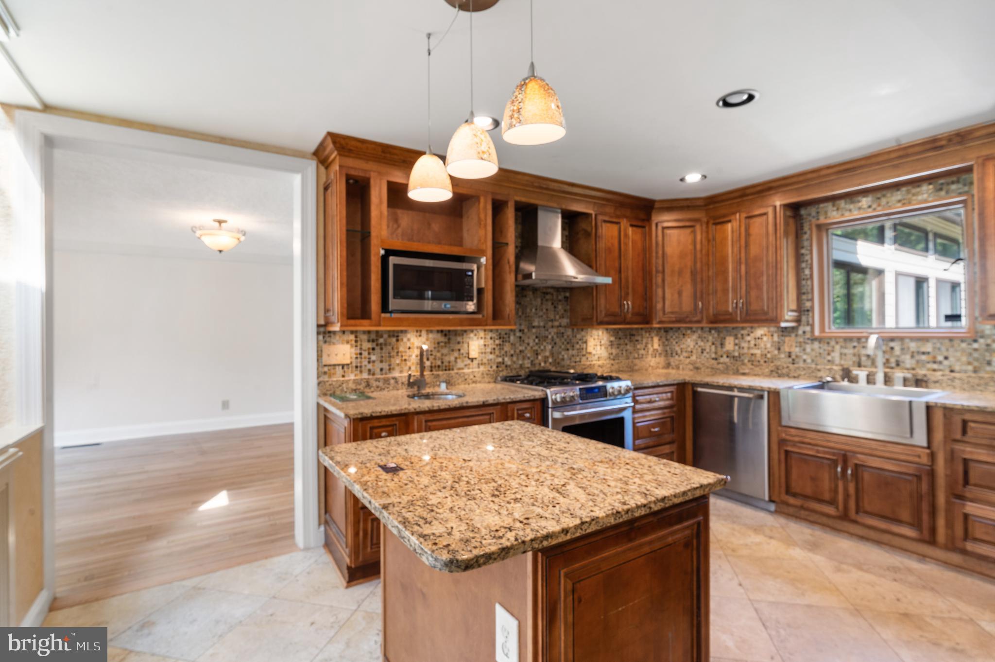 15729 Holly Grove Road Silver Spring, MD 20905 - Photo 9 of 83 Elegant kitchen with rich wood cabinetry.