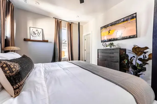 a bedroom with a bed and a flat screen tv