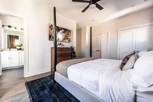 a bedroom with a bed and a chandelier