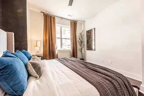 a bedroom with a bed and a window