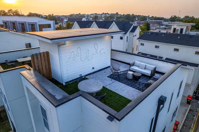 an aerial view of a house with a yard
