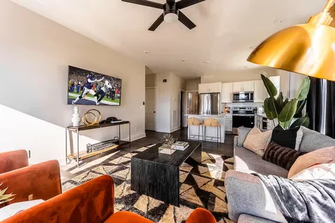 a living room with furniture a couch and a flat screen tv