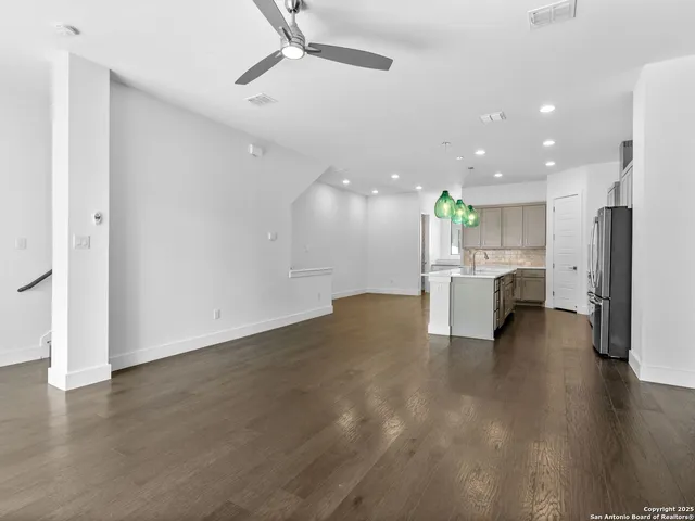 a view of a kitchen with a kitchen island wooden floor and a window
