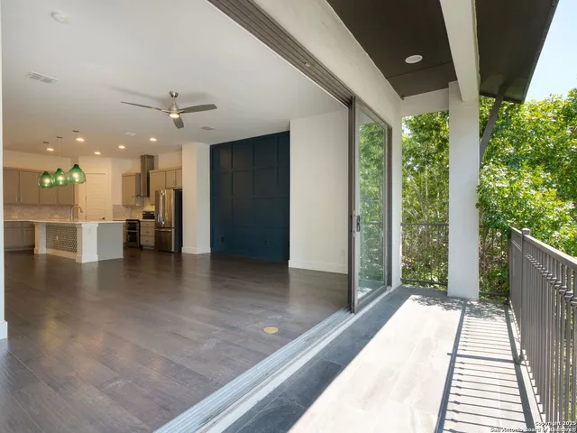 a view of a living room and a balcony