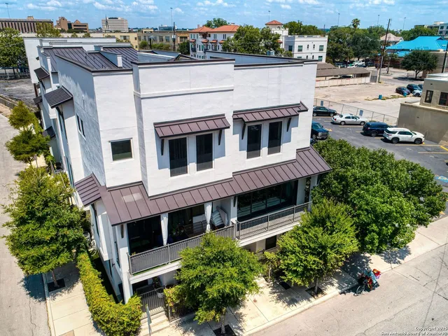 an aerial view of a house with a yard and garage