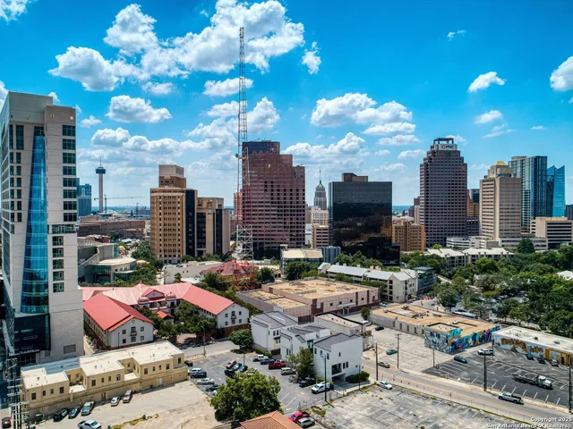 an aerial view of a house with backyard space and lake view
