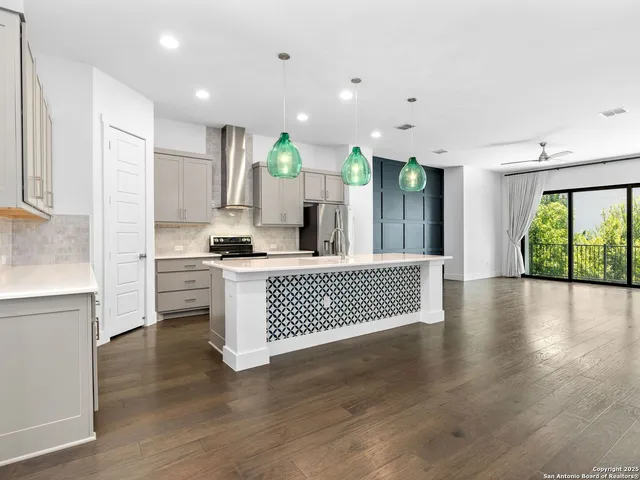 a kitchen with stainless steel appliances a refrigerator sink and cabinets