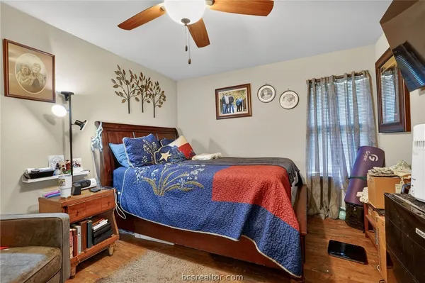 a bed sitting in a bedroom next to a lamp