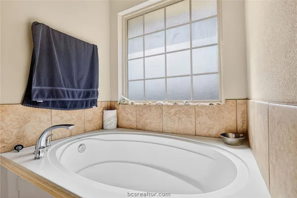 a bathroom with a bathtub and shower