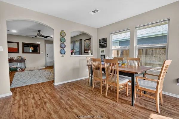 a view of a dining room with furniture and wooden floor