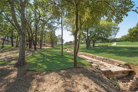 a view of a park with large trees
