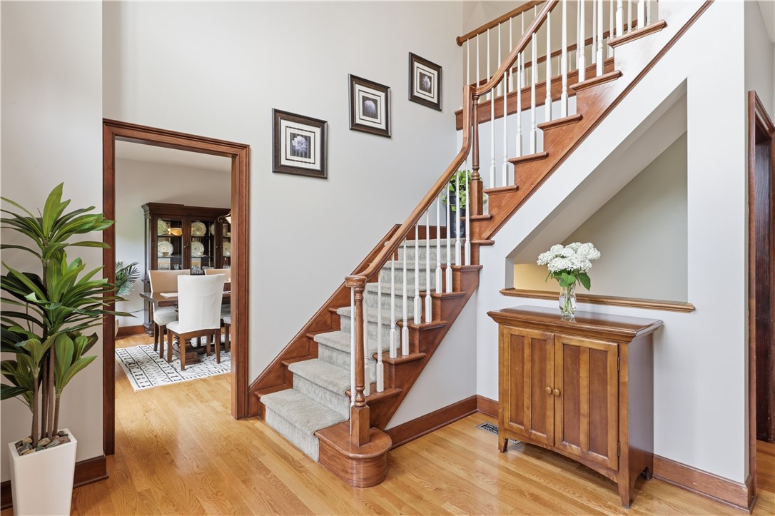 2057 Stirnie Road Victor, NY 14564 - Photo 6 of 48 Step directly through the threshold into a spectacular, sun-drenched grand foyer. The soaring two-story ceiling height instantly provides an open, airy feeling and a view of the dining room.