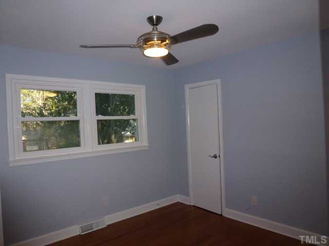 1714 Euclid Road Durham, NC 27713 - Photo 21 of 25 an empty room with windows and chandelier fan