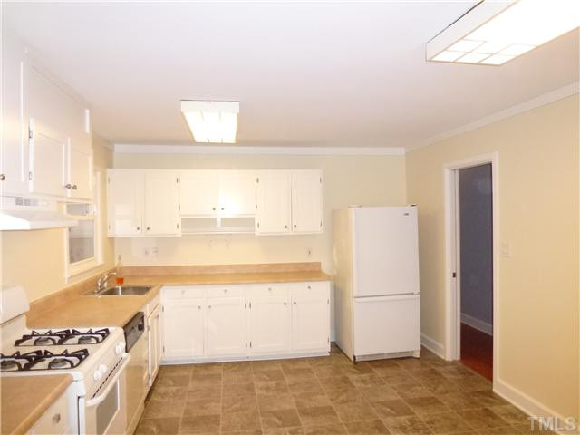 1714 Euclid Road Durham, NC 27713 - Photo 8 of 25 a view of a kitchen with a stove top oven a sink and white cabinets