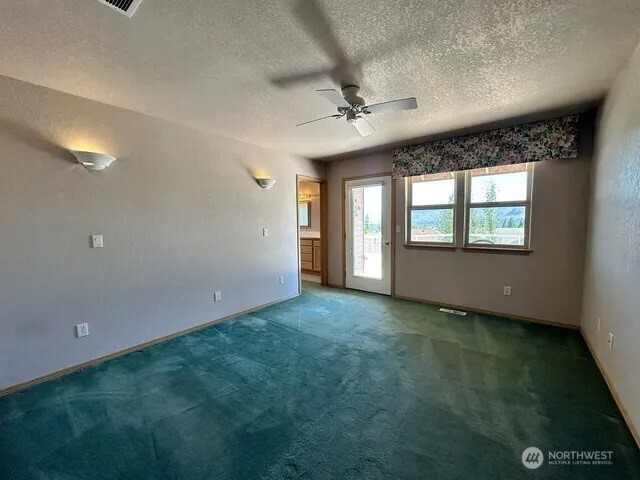 3639 Ridgeview Boulevard Wenatchee, WA 98801 - Photo 32 of 36 en empty room with windows and ceiling fan