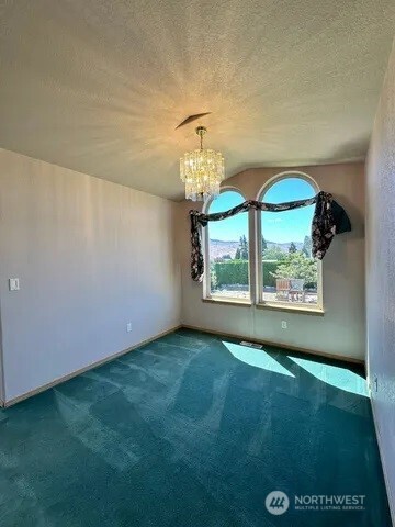 3639 Ridgeview Boulevard Wenatchee, WA 98801 - Photo 35 of 36 an empty room with windows and outdoor view