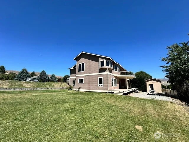 3639 Ridgeview Boulevard Wenatchee, WA 98801 - Photo 36 of 36 a front view of a house with a yard table and chairs