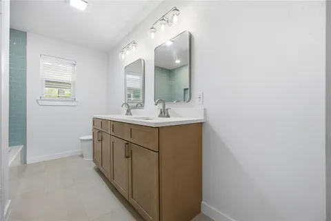 a bathroom with a sink vanity and a mirror