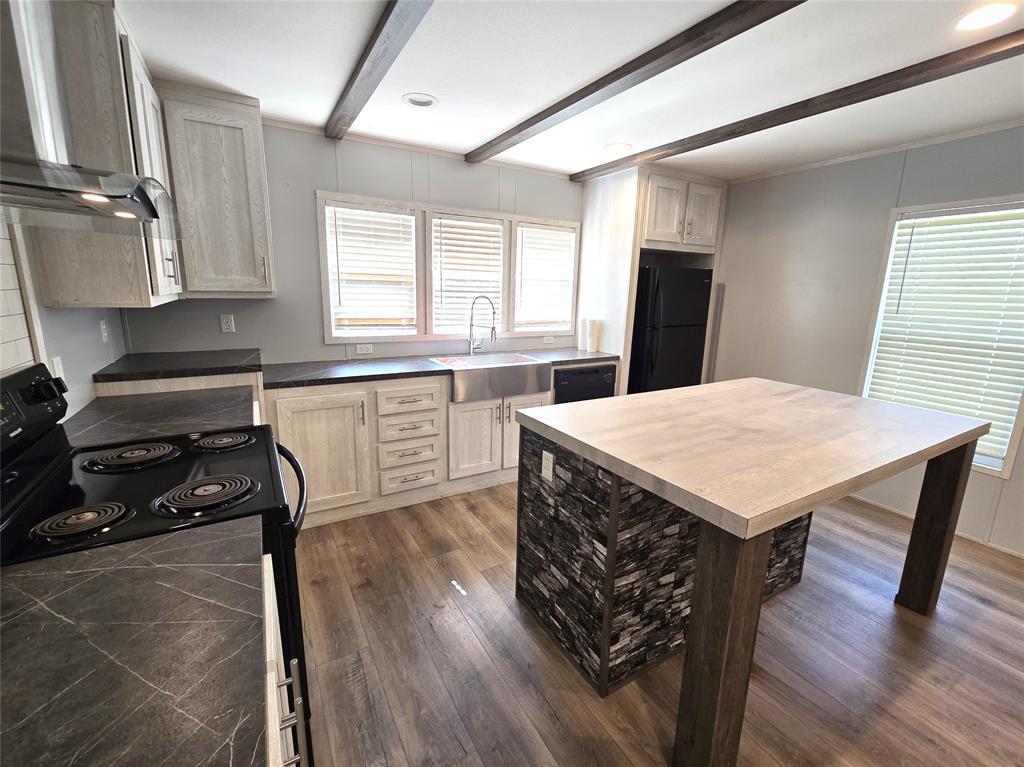 215 Buffalo Way Drive Trinity, TX 75862 - Photo 1 of 17 a kitchen with a table chairs refrigerator and window