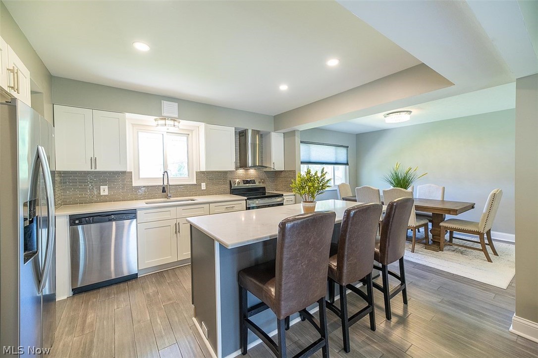 1275 Long Ridge Drive Independence, OH 44131 - Photo 4 of 31 Gather around your recently renovated Kitchen featuring white shaker cabinetry, quartz countertops, S/S appliances, hardwood flooring and a large center Island.