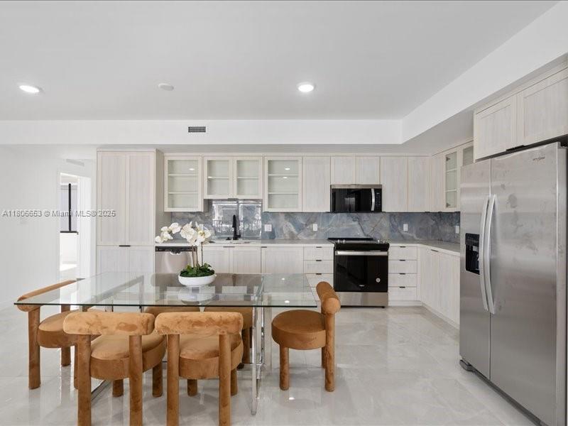 14608 Southwest 261st Terrace Homestead, FL 33032 - Photo 13 of 26 a kitchen with granite countertop white cabinets and stainless steel appliances