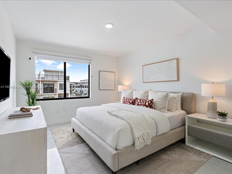 14608 Southwest 261st Terrace Homestead, FL 33032 - Photo 19 of 26 a bedroom with a large bed and a couch