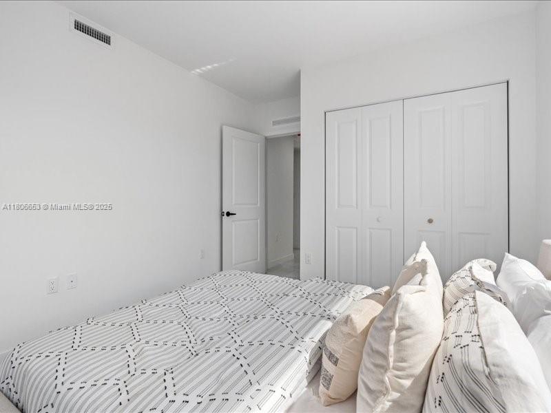 14608 Southwest 261st Terrace Homestead, FL 33032 - Photo 25 of 26 a bedroom with a bed and white cabinet