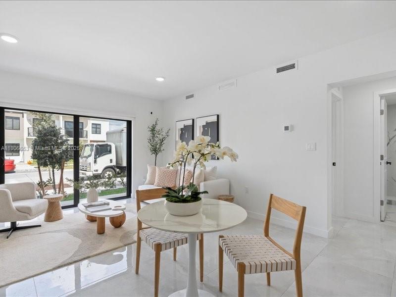 14608 Southwest 261st Terrace Homestead, FL 33032 - Photo 5 of 26 a view of a dining room with furniture wooden floor and a large window